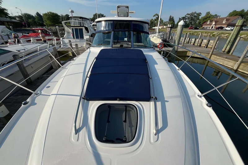 Slide: The Image of 2006 Sea Ray 380 Sundancer yacht docked at marina, featuring sleek design and spacious deck. - 9