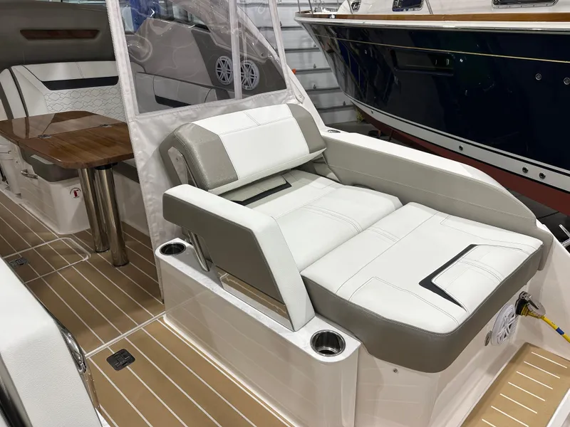 Slide: The Image of 2024 Tiara Yachts 34 LX interior with luxurious seating and wooden table. - 11
