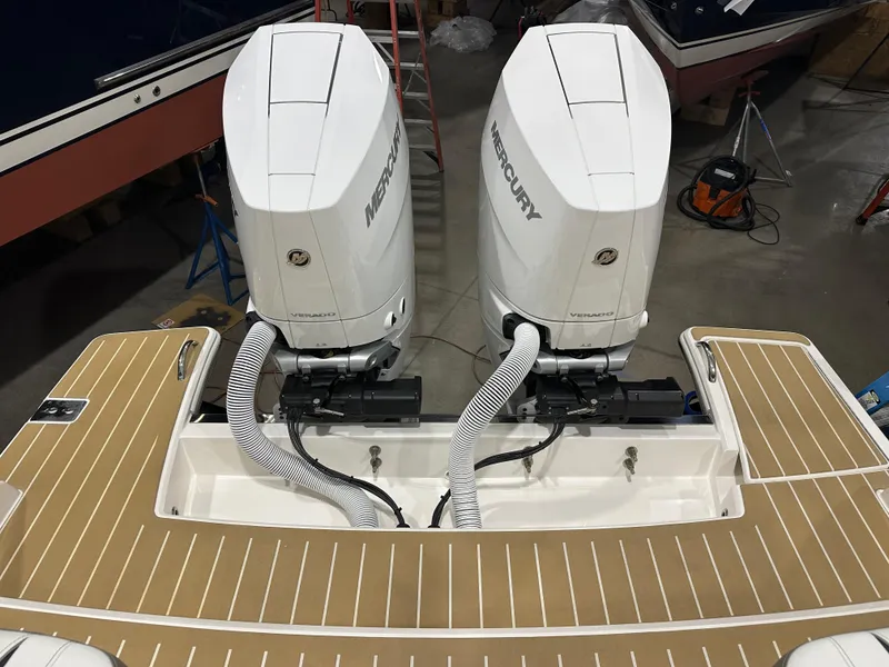 Slide: The Image of 2024 Tiara Yachts 34 LX with dual Mercury outboard engines on teak deck. - 14
