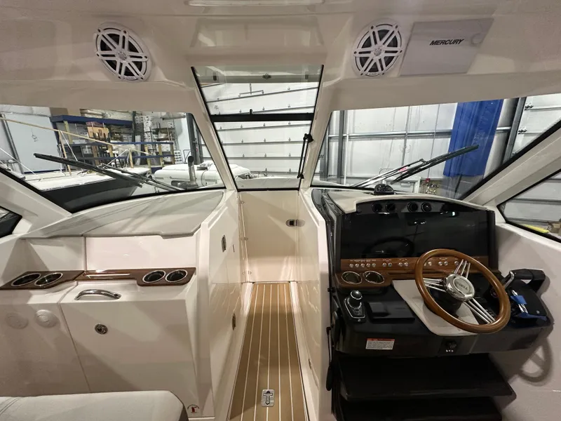 Slide: The Image of 2024 Tiara Yachts 34 LX cockpit with modern steering and control panel. - 16