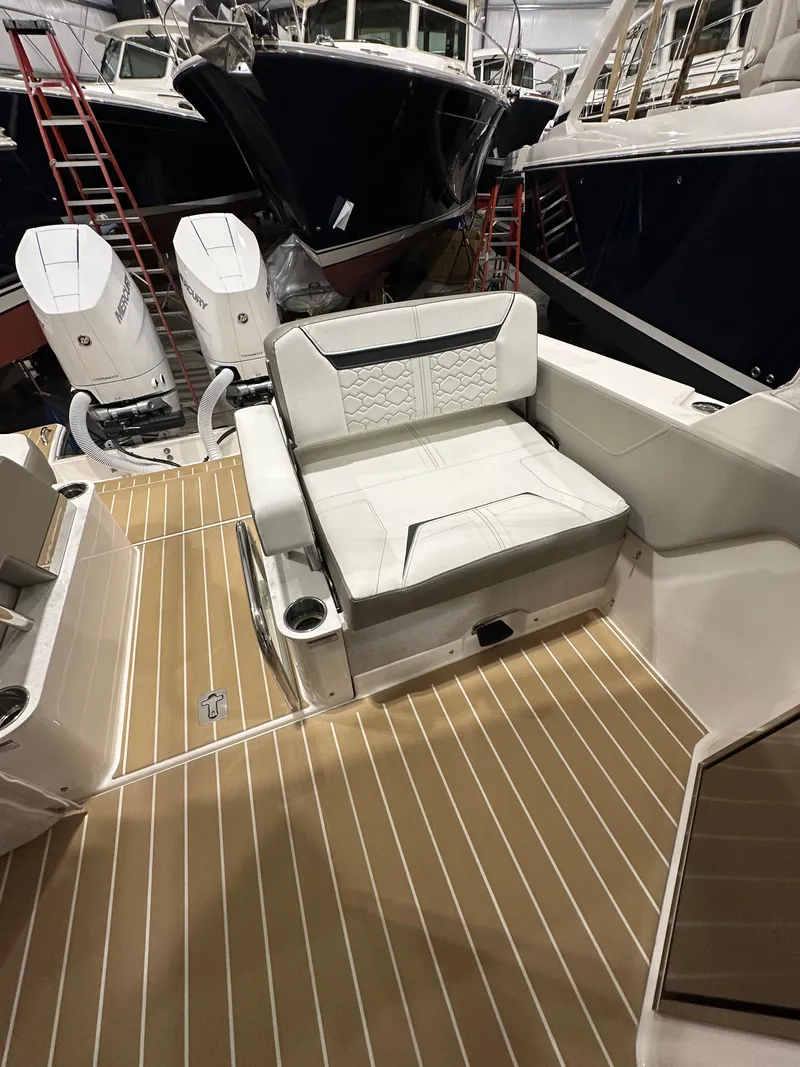 Slide: The Image of 2024 Tiara Yachts 34 LX interior with white seating and teak flooring. - 4