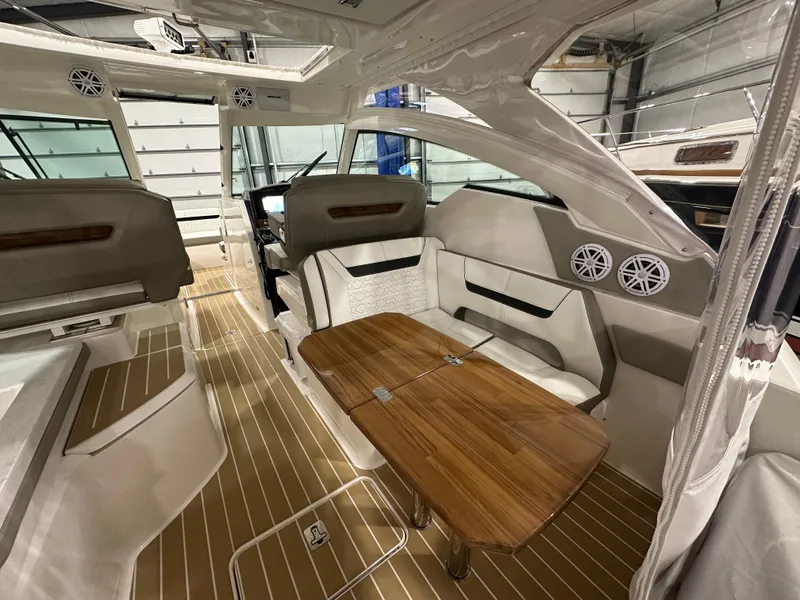 Slide: The Image of 2024 Tiara Yachts 34 LX interior with elegant seating and wooden table. - 7