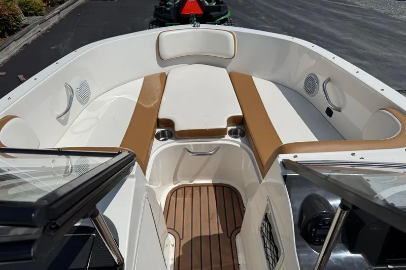 Slide: The Image of 2022 Bayliner VR4 Bowrider OB interior with tan and white seating, wood flooring. - 14
