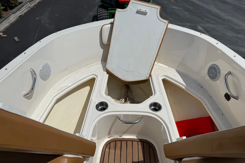Slide: The Image of 2022 Bayliner VR4 Bowrider OB interior with storage compartments and cup holders. - 15