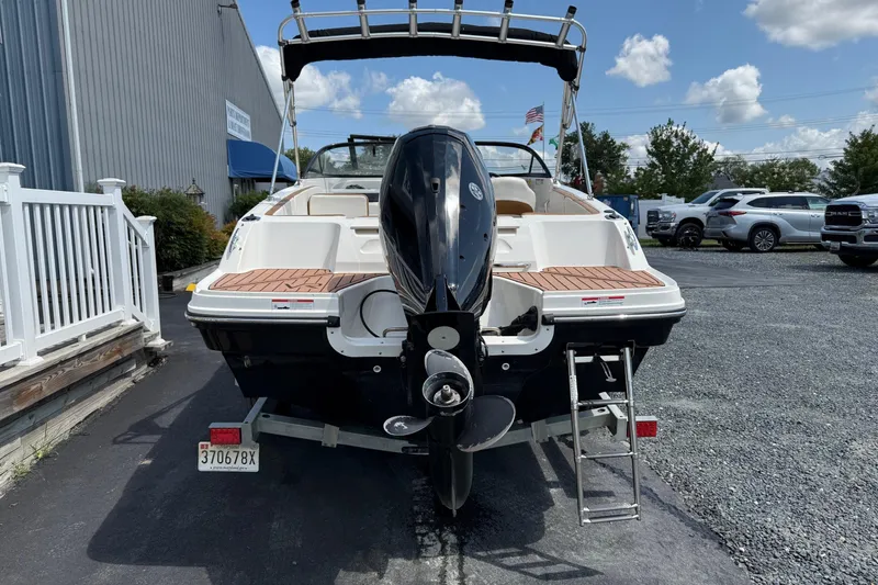 Slide: The Image of 2022 Bayliner VR4 Bowrider OB boat with outboard motor, parked outdoors. - 2