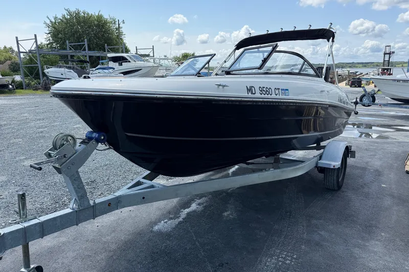 Slide: The Image of 2022 Bayliner VR4 Bowrider OB on trailer, parked outdoors under a cloudy sky. - 3