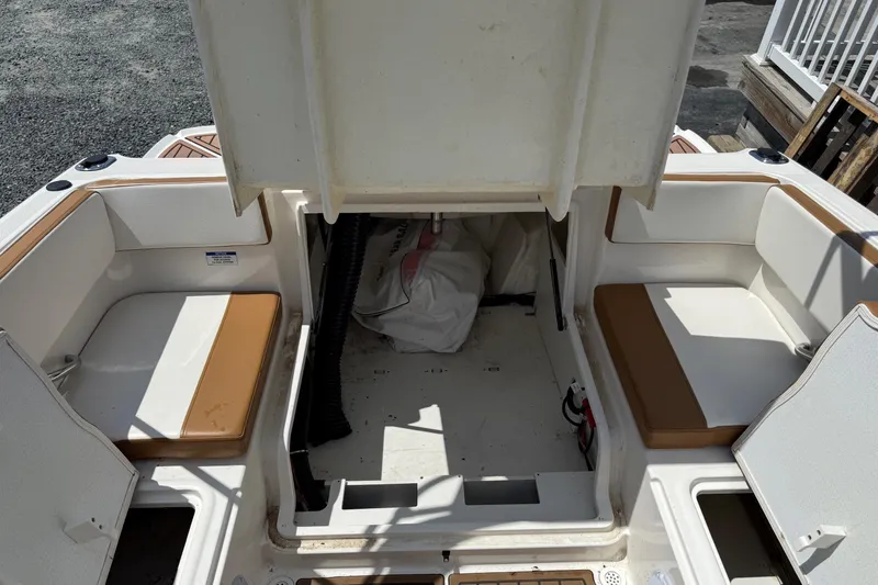 Slide: The Image of 2022 Bayliner VR4 Bowrider OB interior with open storage compartments and seating. - 8