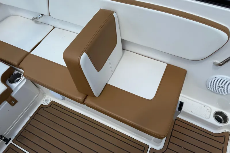 Slide: The Image of 2022 Bayliner VR4 Bowrider OB interior seating with brown and white upholstery. - 9