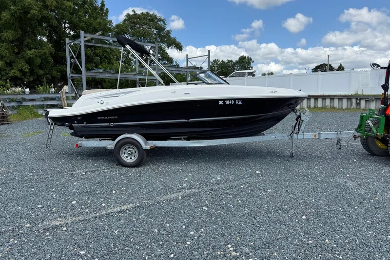 The Image of 2016 Bayliner VR5 Bowrider on trailer, parked outdoors under blue sky. - 0