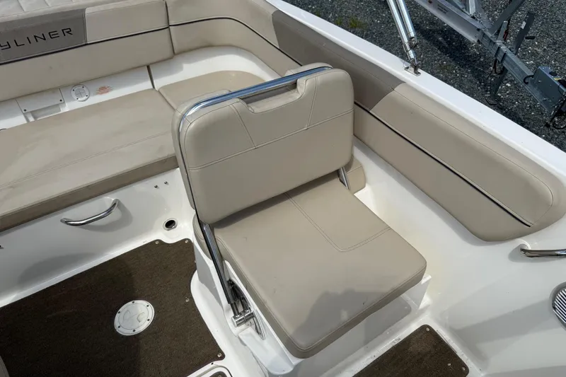 Slide: The Image of 2016 Bayliner VR5 Bowrider interior with beige seating and stainless steel accents. - 10