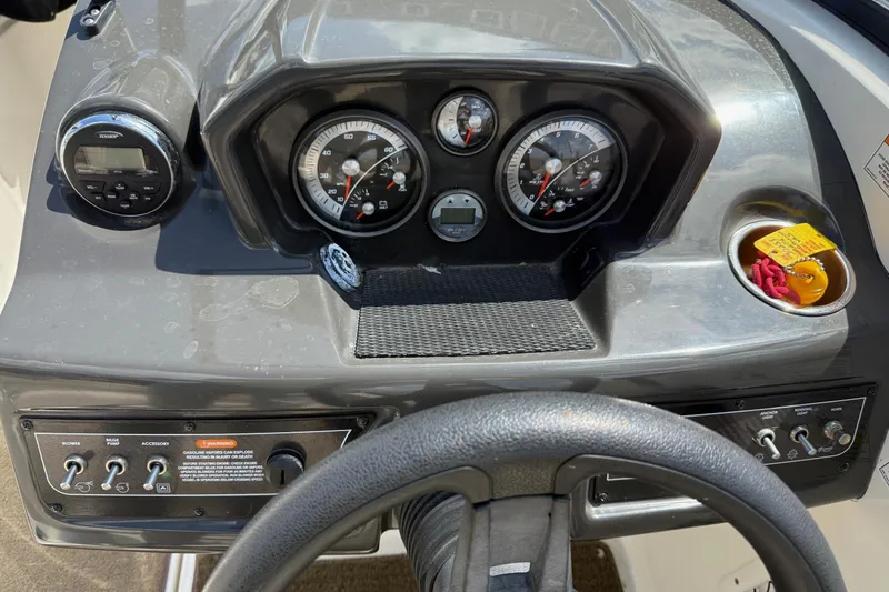 Slide: The Image of Dashboard of a 2016 Bayliner VR5 Bowrider boat with gauges and controls. - 12