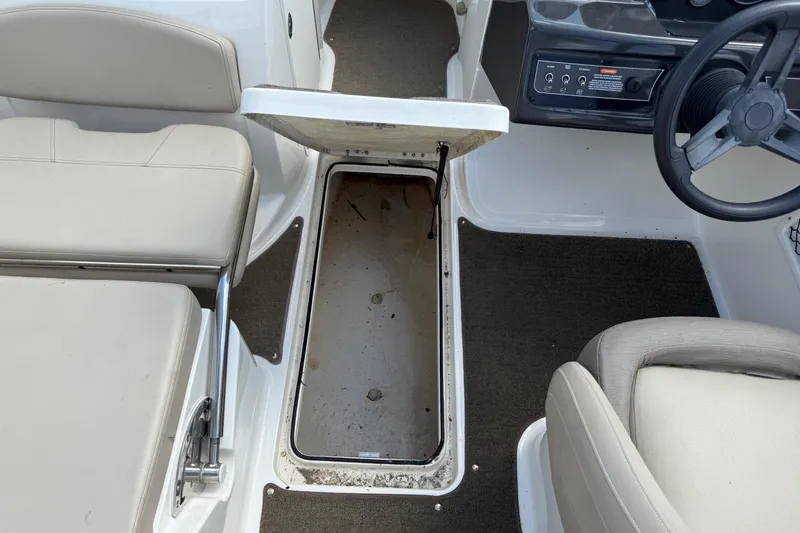 Slide: The Image of 2016 Bayliner VR5 Bowrider interior with open storage compartment and steering wheel. - 13