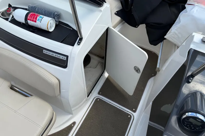 Slide: The Image of 2016 Bayliner VR5 Bowrider interior with open storage compartment and safety equipment. - 14