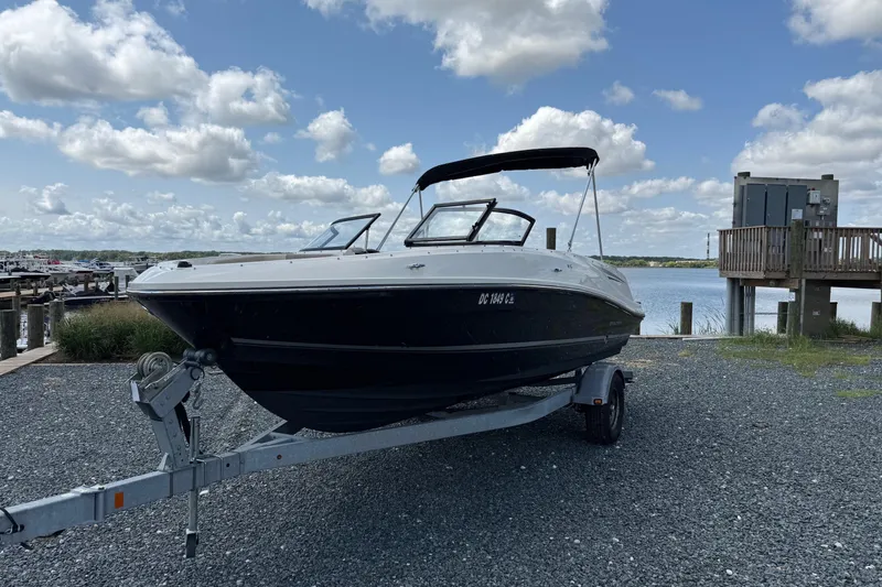 Slide: The Image of 2016 Bayliner VR5 Bowrider on trailer by a scenic waterfront under cloudy sky. - 6