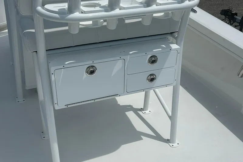 Slide: The Image of 2026 Pair Customs 21 Center Console MV boat storage compartments and seating detail. - 2