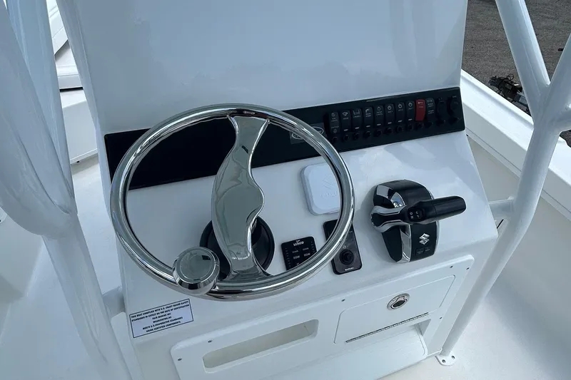 Slide: The Image of Steering console of 2026 Pair Customs 21 Center Console MV boat, featuring modern controls. - 6