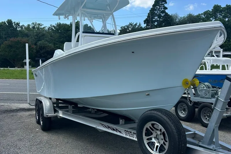 Slide: The Image of 2026 Pair Customs 21 Center Console MV boat on trailer, parked outdoors. - 7