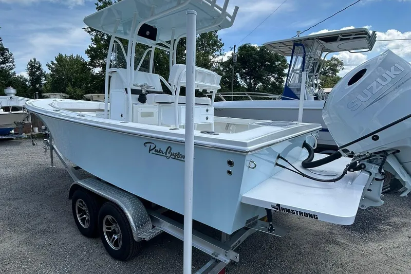 Slide: The Image of 2026 Pair Customs 21 Center Console MV boat on trailer with Suzuki outboard motor. - 8
