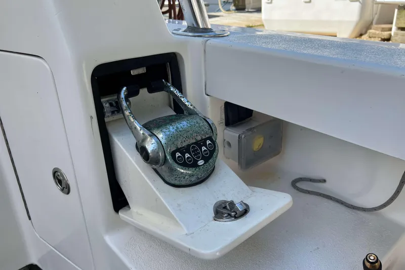 Slide: The Image of Teak deck of 2007 Henriques 42 Express boat with metal fittings and coiled hose. - 10