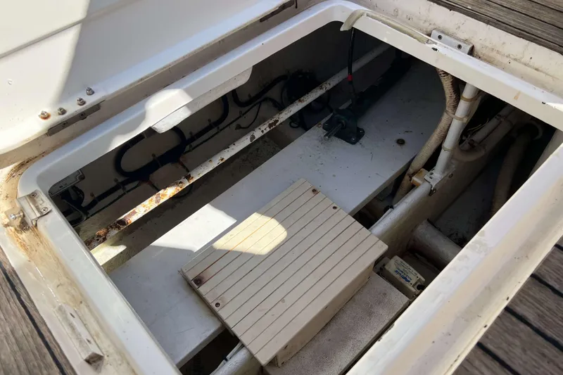 Slide: The Image of Engine compartment of 2007 Henriques 42 Express boat, showing mechanical components and pipes. - 16