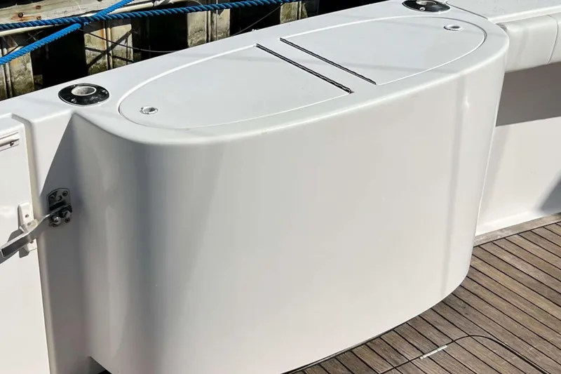 Slide: The Image of Open storage compartment on 2007 Henriques 42 Express boat, docked with blue rope. - 20