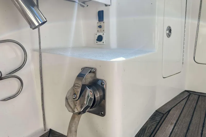 Slide: The Image of 2007 Henriques 42 Express boat interior with seating and storage compartments. - 26