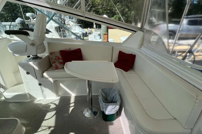 Slide: The Image of Captain's chair on 2007 Henriques 42 Express boat, featuring white upholstery and helm view. - 29