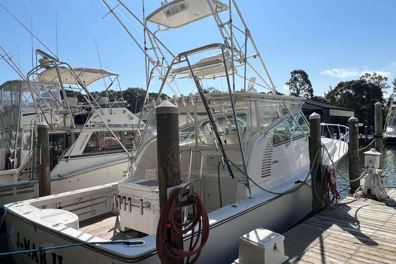 Slide: The Image of 2007 Henriques 42 Express boat interior with fishing equipment and wooden deck. - 3