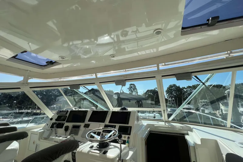 Slide: The Image of 2007 Henriques 42 Express boat interior with white cushioned seating. - 31