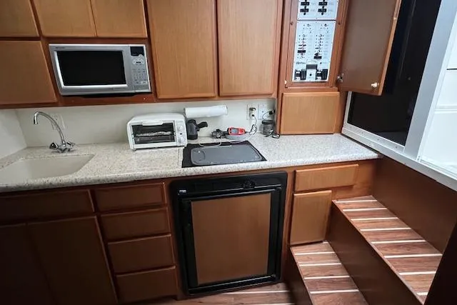 Slide: The Image of 2007 Henriques 42 Express yacht kitchen with microwave, sink, and control panel. - 36