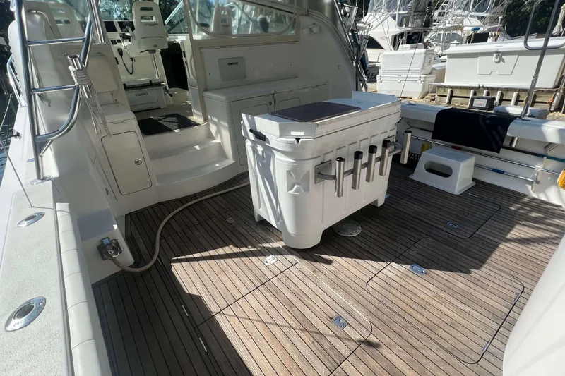 Slide: The Image of 2007 Henriques 42 Express boat interior with Simrad equipment and storage cabinets. - 4