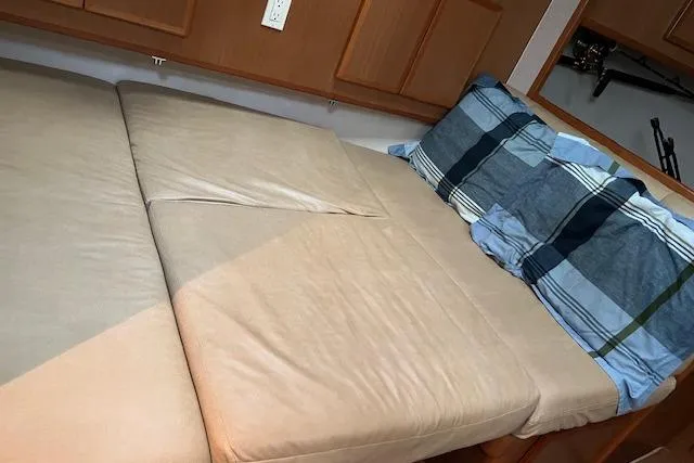 Slide: The Image of 2007 Henriques 42 Express cabin interior with wooden table and beige seating. - 40