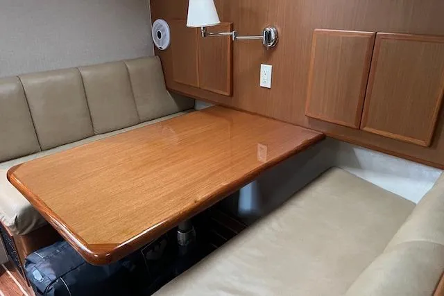 Slide: The Image of 2007 Henriques 42 Express cabin interior with cozy bedding and fishing rods. - 41