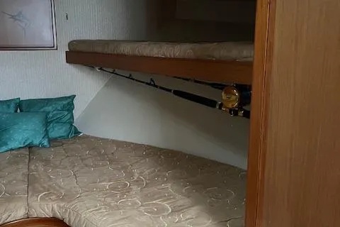 Slide: The Image of 2007 Henriques 42 Express boat deck with fishing rod holders and teak flooring. - 43