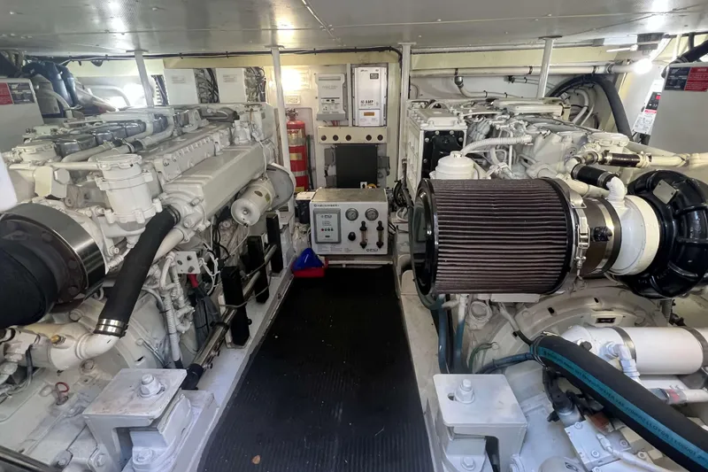 Slide: The Image of Engine room of a 2007 Henriques 42 Express boat, showcasing mechanical components and filters. - 47