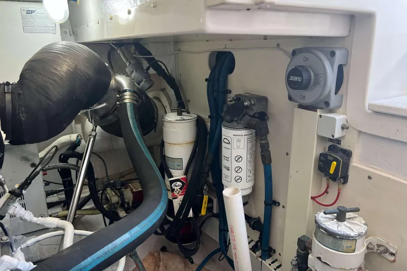 Slide: The Image of Engine compartment of a 2007 Henriques 42 Express boat, showing fuel filters and wiring. - 48