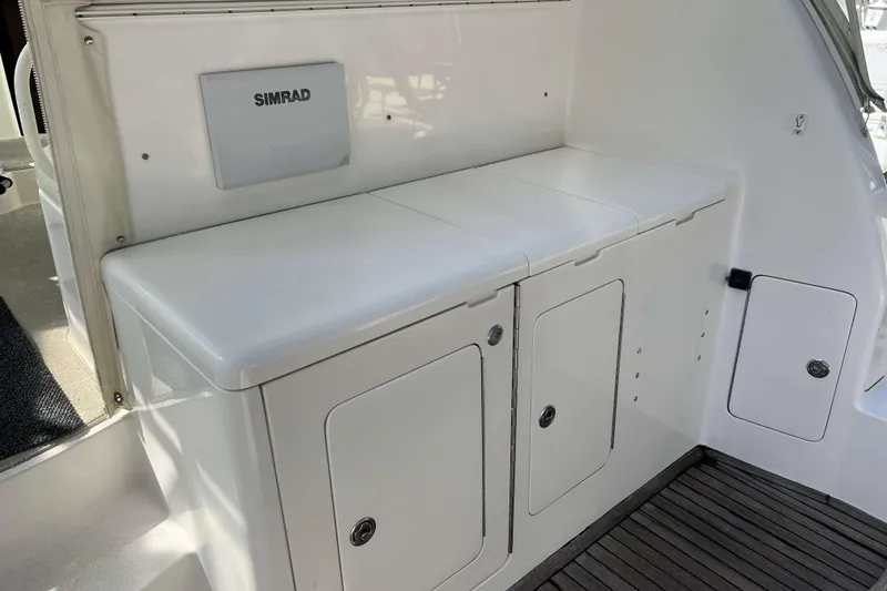 Slide: The Image of Open storage compartments on a 2007 Henriques 42 Express boat, showing interior space. - 5