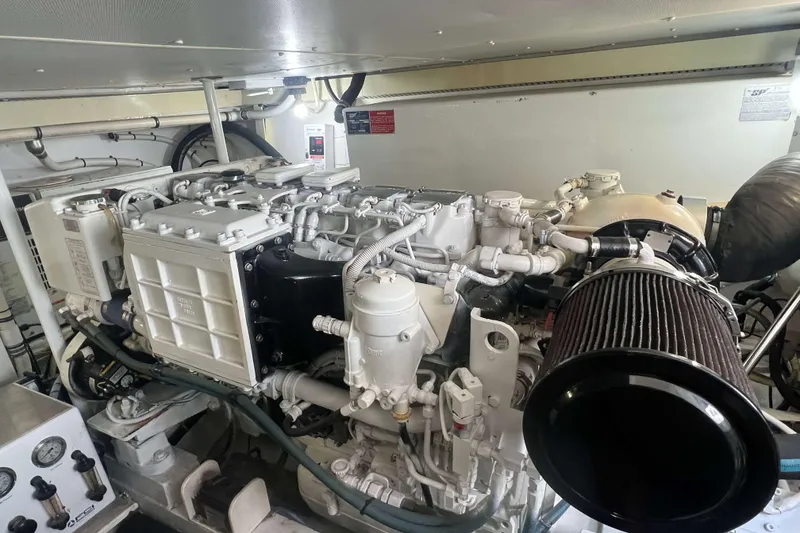 Slide: The Image of Engine room of 2007 Henriques 42 Express with battery charger and fire extinguisher. - 52