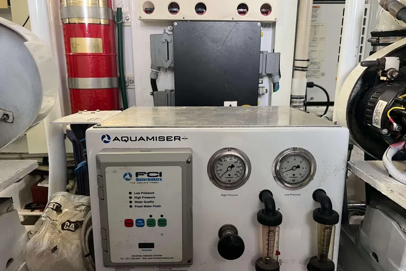 Slide: The Image of Engine room of 2007 Henriques 42 Express with fire extinguisher and water filtration system. - 54