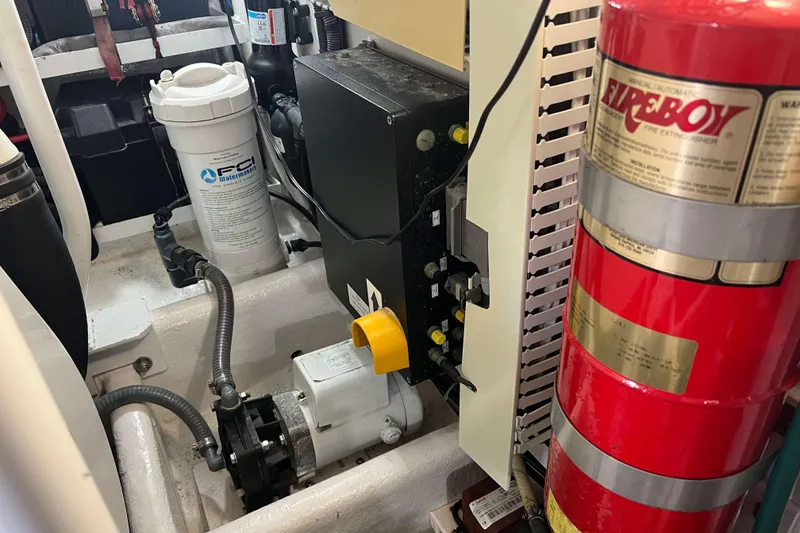 Slide: The Image of Engine room of 2007 Henriques 42 Express with electrical components and storage shelves. - 55