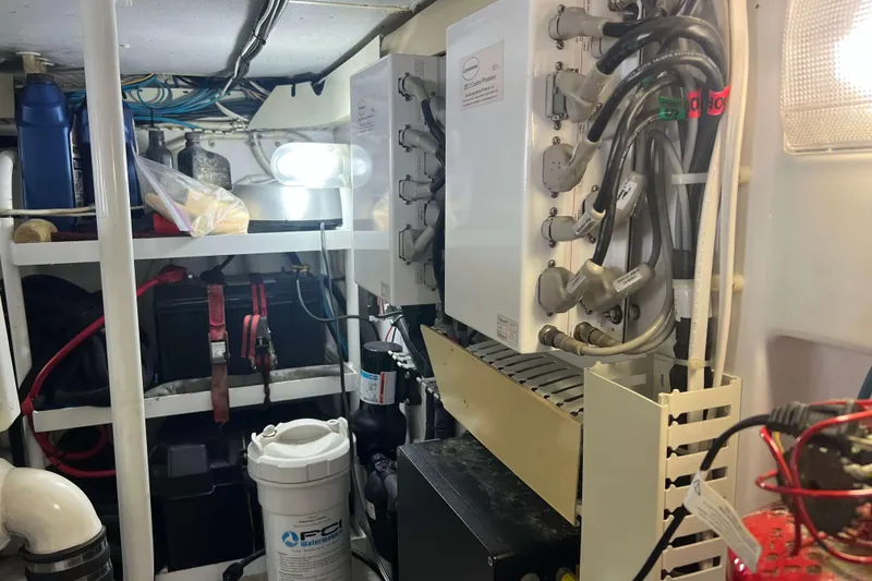 Slide: The Image of Battery storage area on a 2007 Henriques 42 Express boat with cables and straps. - 56