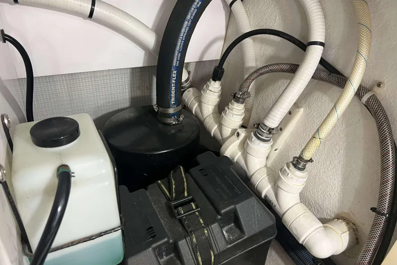 Slide: The Image of Engine room of a 2007 Henriques 42 Express boat, featuring various equipment and wiring. - 62