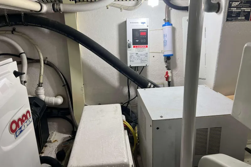Slide: The Image of Dometic control panel and filter system on a 2007 Henriques 42 Express boat. - 63