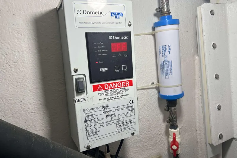 Slide: The Image of Engine room of a 2007 Henriques 42 Express boat, featuring equipment and labels. - 64