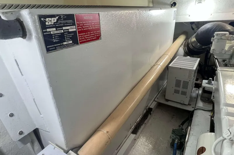 Slide: The Image of Fuel tank label on 2007 Henriques 42 Express, 100-gallon capacity, compliance notice. - 65