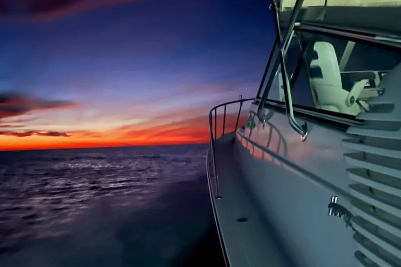 Slide: The Image of Henriques 42 Express 2007 yacht cruising at sunset on the ocean. - 83