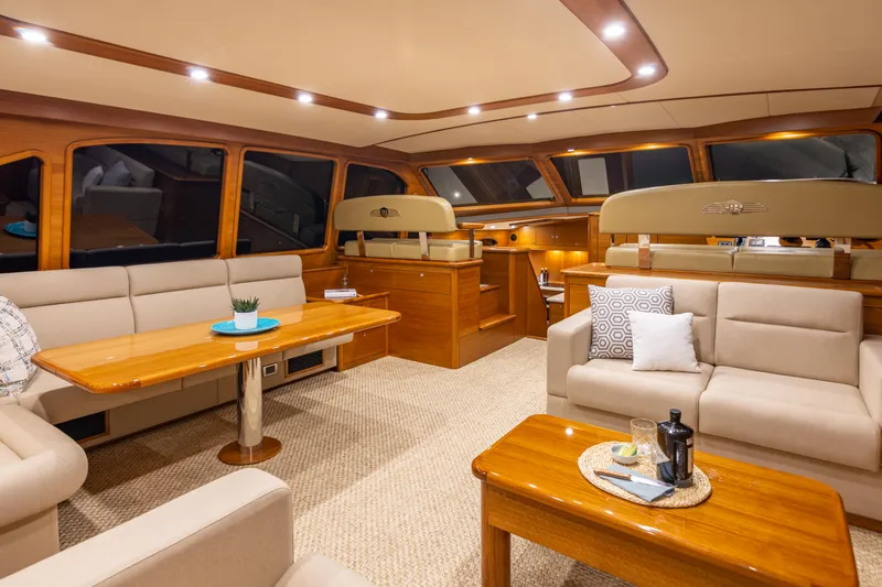Slide: The Image of Luxurious interior of 2021 Palm Beach Motor Yachts PB65 with elegant seating and wooden accents. - 16