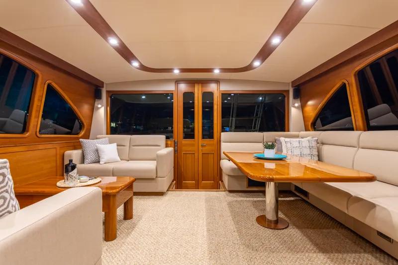Slide: The Image of Luxurious interior of 2021 Palm Beach Motor Yachts PB65 with elegant seating and wooden accents. - 17