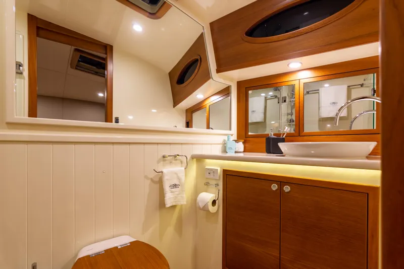Slide: The Image of Luxurious bathroom in 2021 Palm Beach Motor Yachts PB65, featuring elegant wood accents. - 25