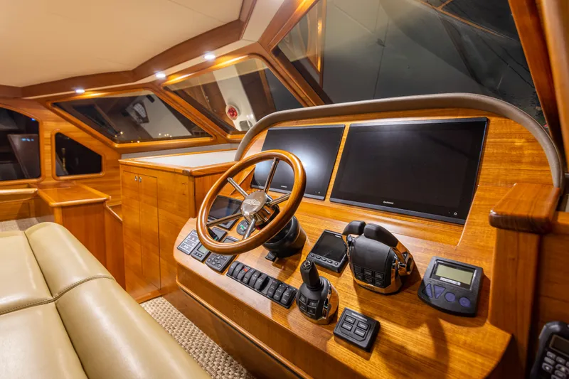 Slide: The Image of Luxurious 2021 Palm Beach Motor Yachts PB65 helm with wood finish and modern controls. - 7